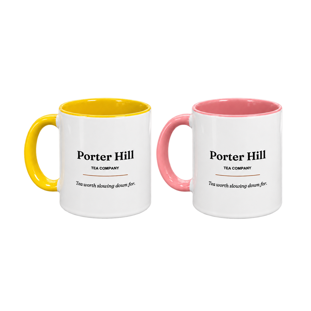 Two Porter Hill tea mugs, one yellow and one pink, with white exteriors and matching coloured handles and interiors
