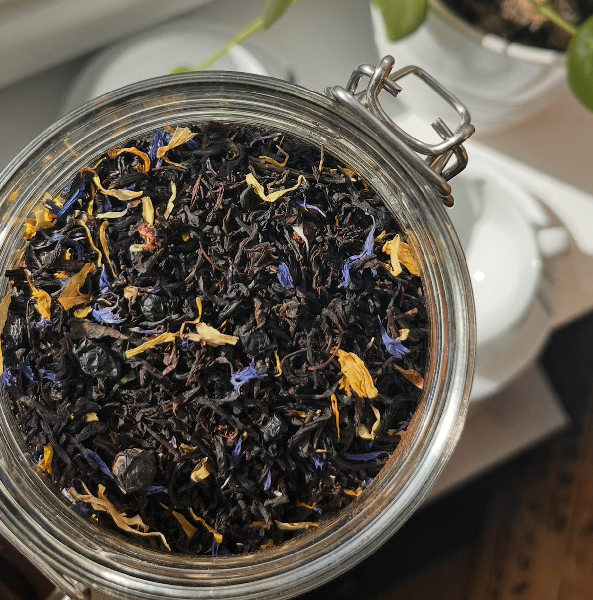 Blueberry Maple loose leaf black tea with cornflower petals in an open tin
