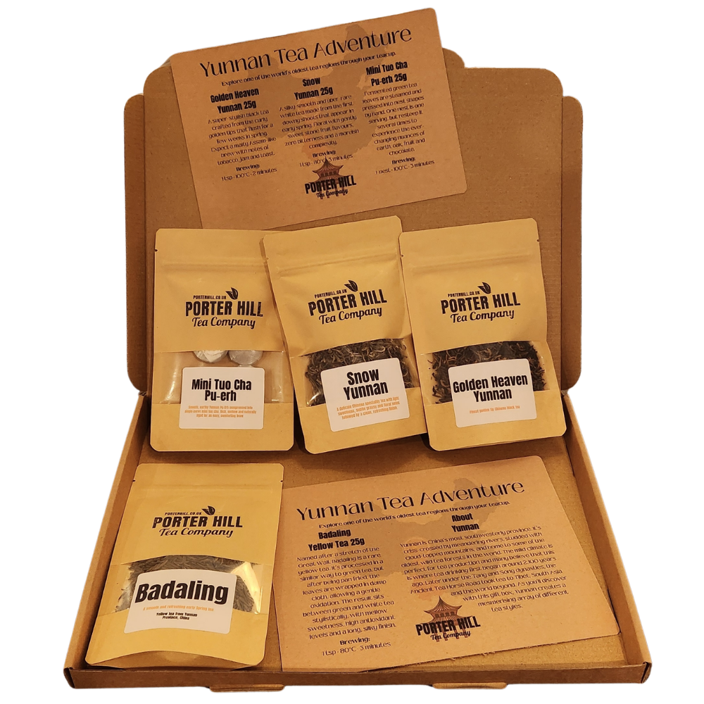 A Porter Hill Tea Company Yunnan Tea Adventure gift box set containing five different tea pouches arranged inside a brown cardboard box with printed tea guides.