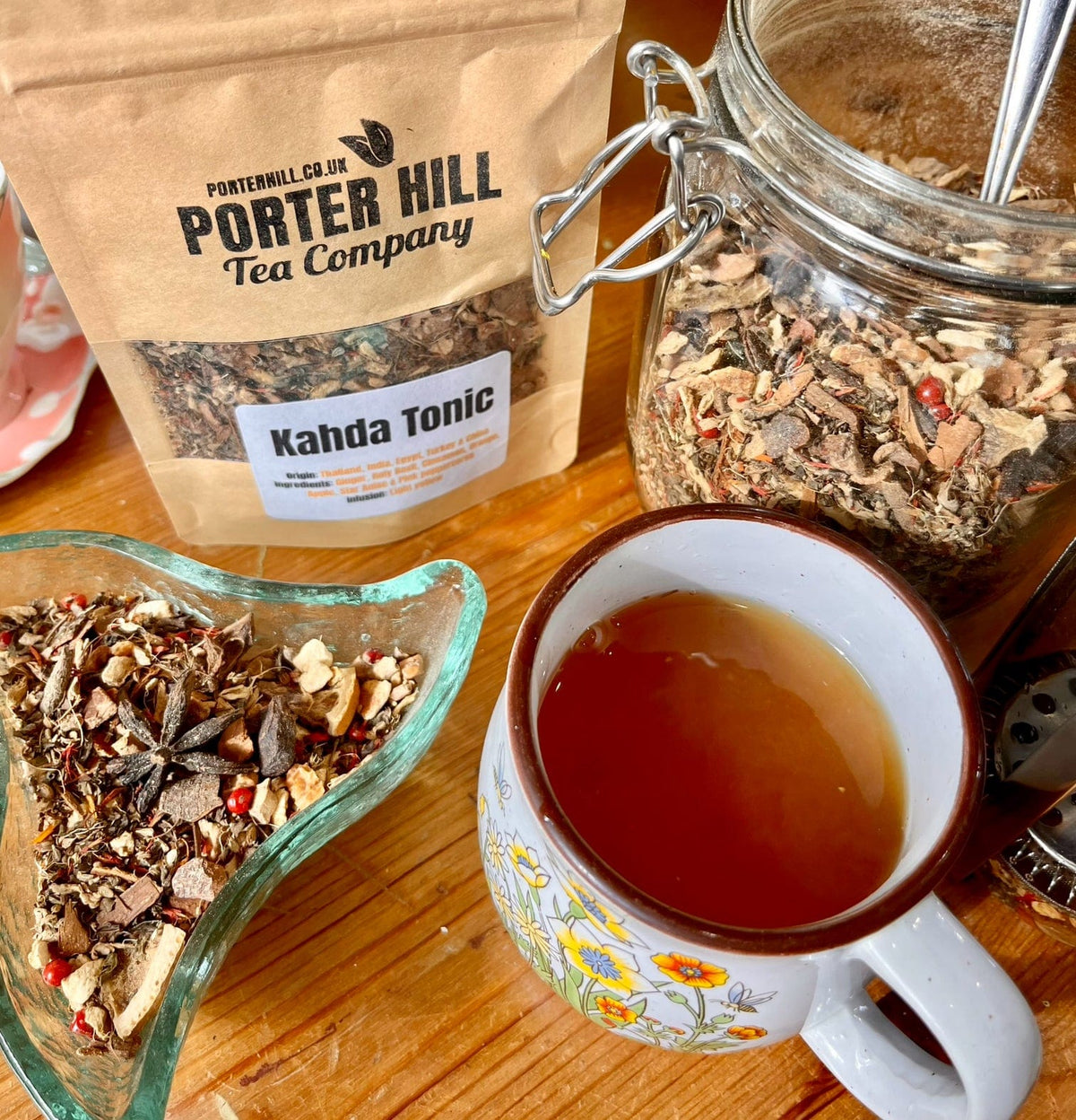 Kadha Tonic tea and ingredients photographed with its Porter Hill pouch