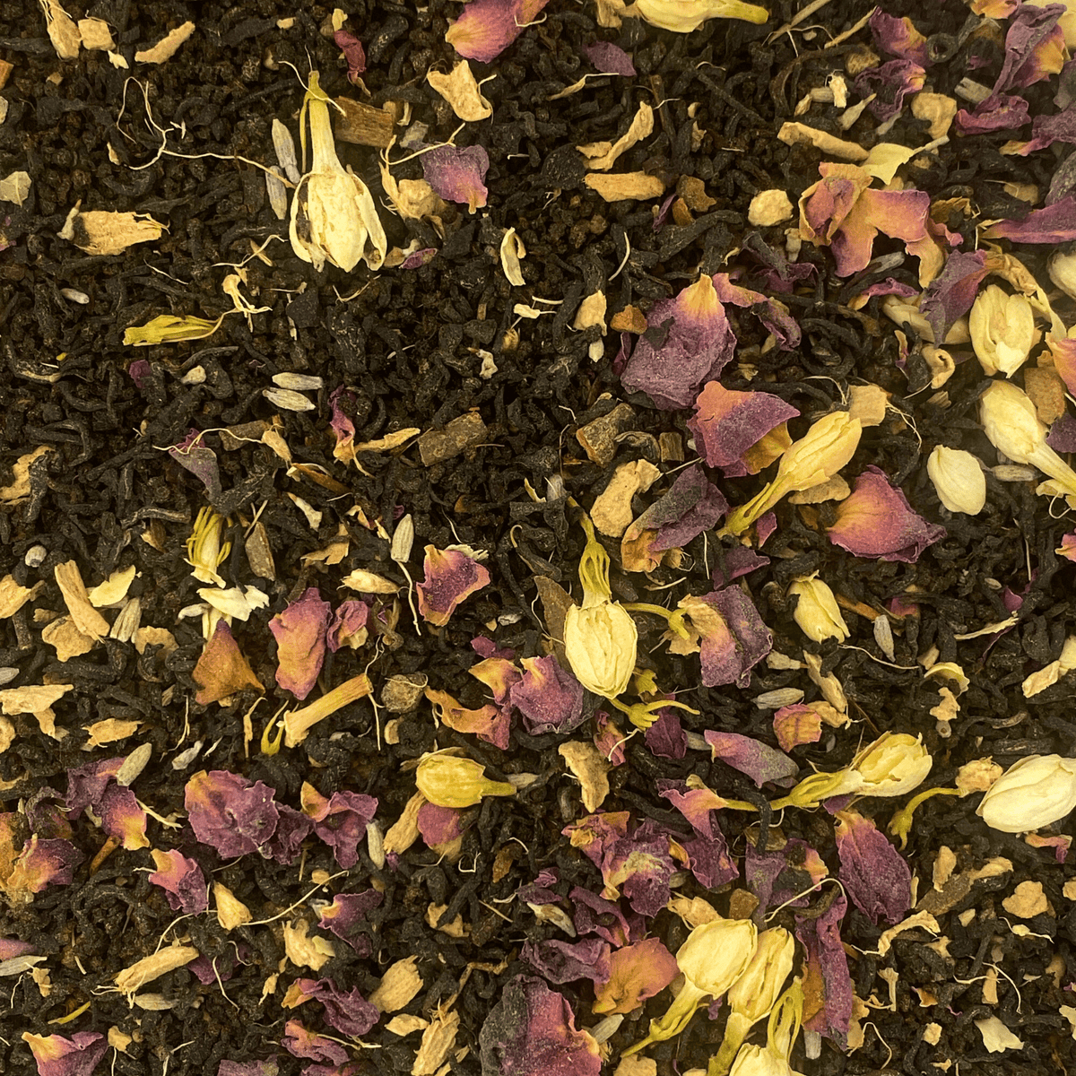 Close-up of Jasmine Masala Chai with black tea, spices and flower petals