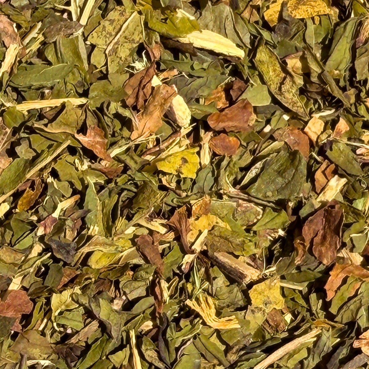 Close-up of chopped peppermint leaves and pale liquorice root pieces