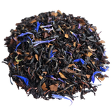 Pile of dark Terrier Tea blend with brown leaf pieces and blue cornflower petals