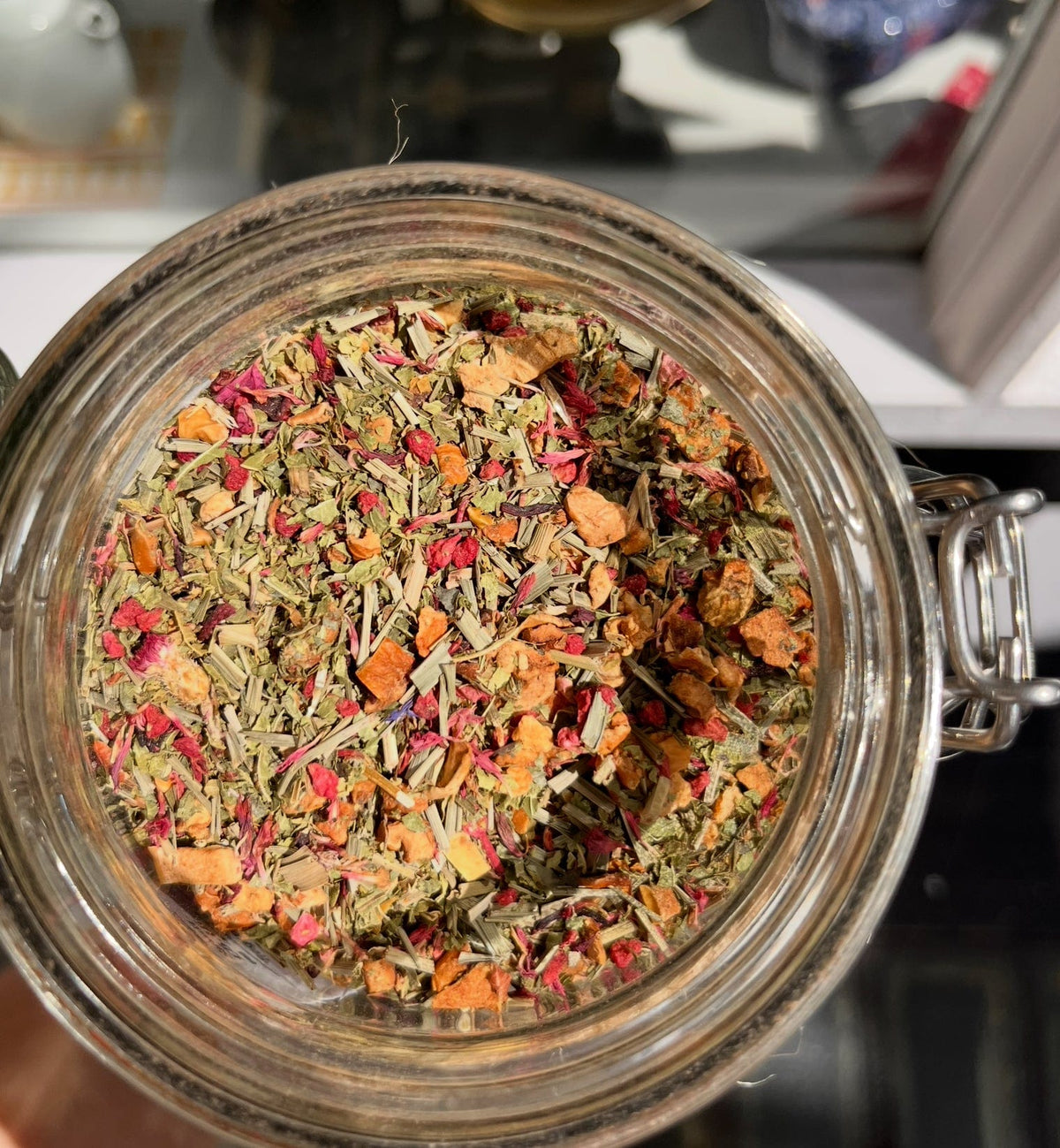 Raspberry Lemon Verbena herbal blend in an open tea jar
