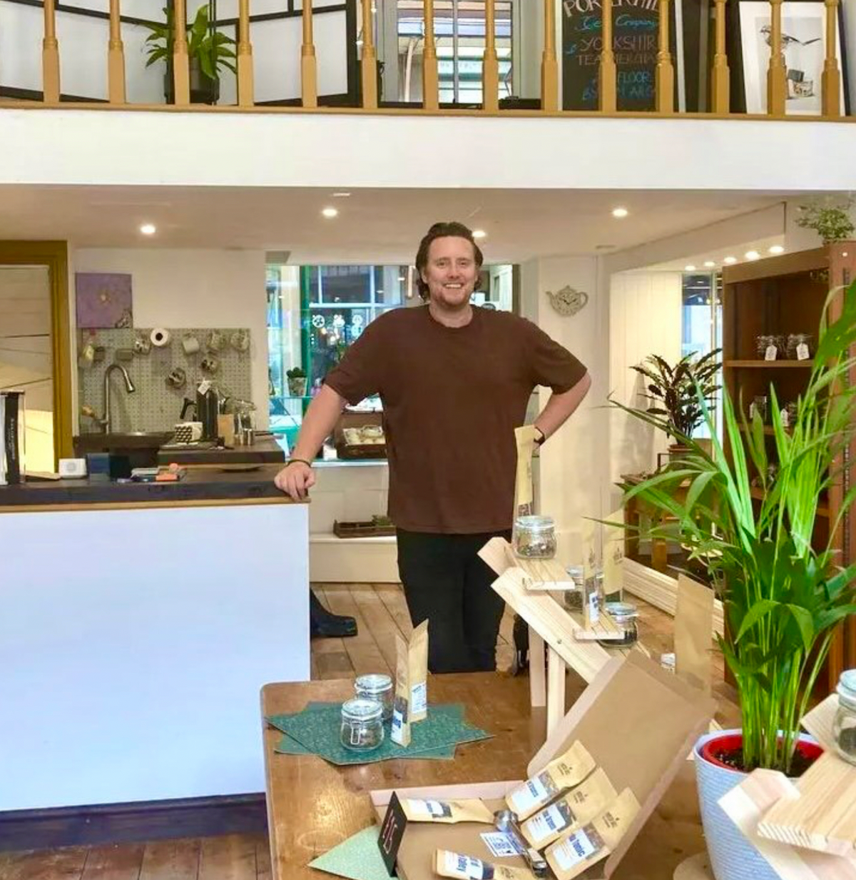 Matt in the Porter Hill tea shop, beside the counter and tea shelves