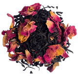 Pile of loose Keemun black tea leaves mixed with dried pink rose petals