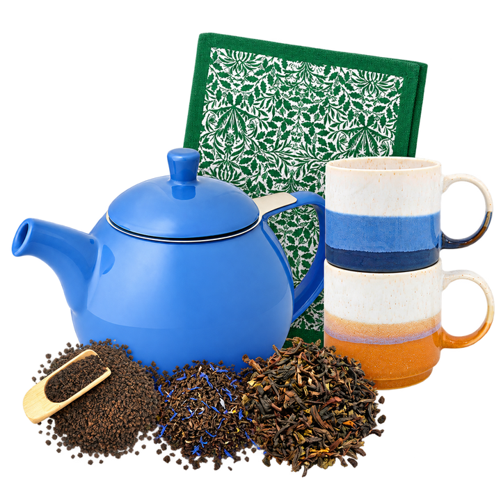 The Complete Tea Ritual: blue FORLIFE teapot, two stacked Elements mugs, Acorn tea towel and three loose leaf teas arranged in a compact overlapping group.