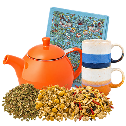 Herbal Tea Ritual with a Carrot orange FORLIFE teapot, two Elements mugs, a blue Strawberry Thief tea towel and three herbal teas.