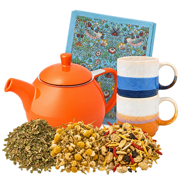 Herbal Tea Ritual with a Carrot orange FORLIFE teapot, two Elements mugs, a blue Strawberry Thief tea towel and three herbal teas.