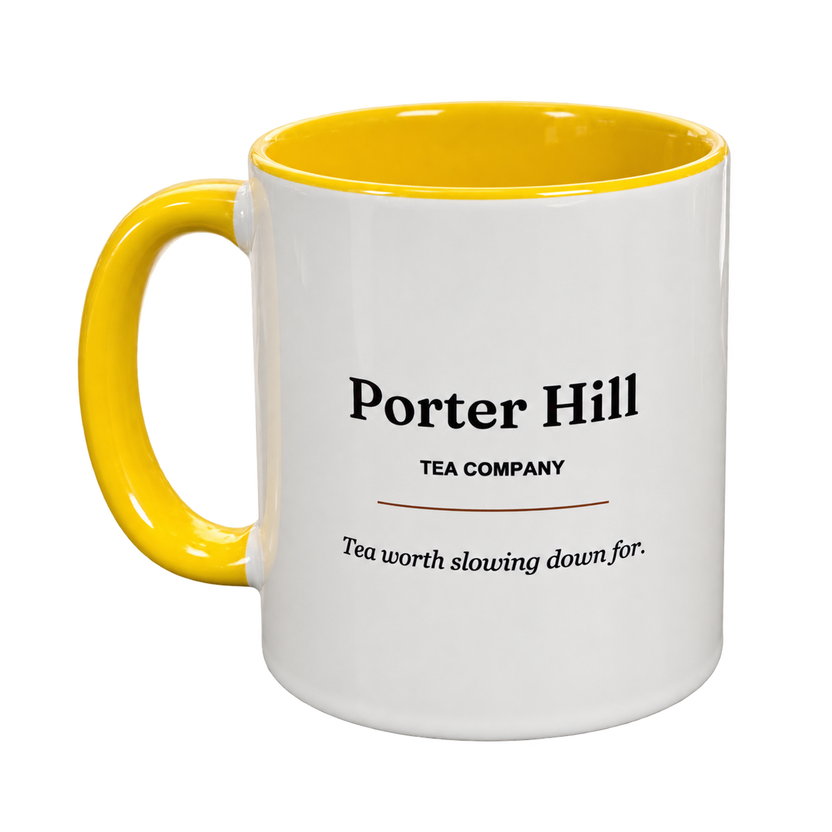 White Porter Hill tea mug with yellow handle and interior, showing the Porter Hill logo and Tea worth slowing down for slogan